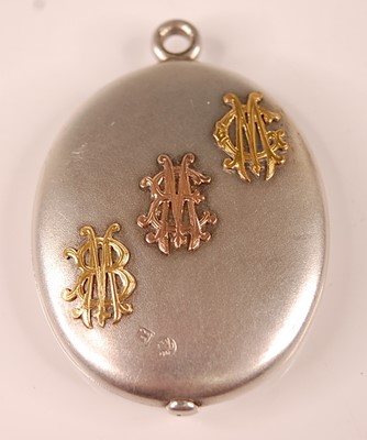 Lot 3105 - A heavy white metal oval locket, having three...