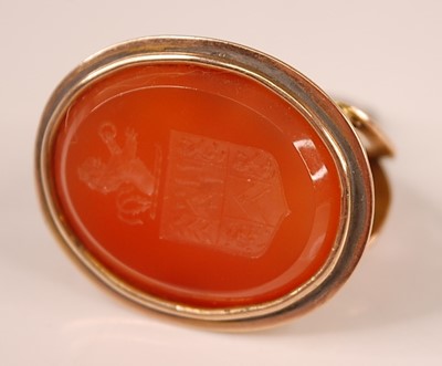 Lot 3106 - A yellow metal carnelian fob seal, the oval...