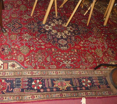 Lot 3336 - A Persian woollen Kashan carpet, having a red...