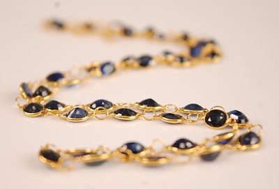 Lot 3091 - A contemporary yellow metal sapphire set...