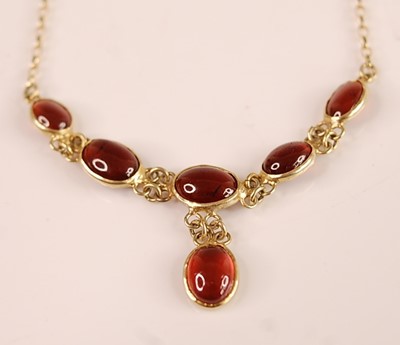 Lot 3119 - A contemporary 9ct gold cabochon garnet set...