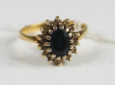 Lot 365 - An 18ct yellow and white gold sapphire and...