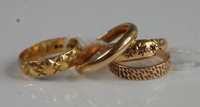 Lot 366 - Four assorted rings - A 9ct yellow gold 3.15mm...