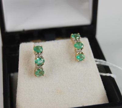 Lot 362 - A pair of yellow metal emerald and white stone...