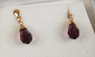 Lot 369 - A pair of yellow metal drop earrings each with...