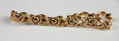 Lot 372 - A 9ct yellow and white gold alternate cross...