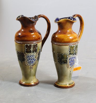 Lot 247 - A pair of Royal Doulton miniature ewers, with...