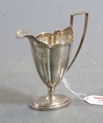 Lot 321 - An Edwardian silver cream jug, of helmet shape,...