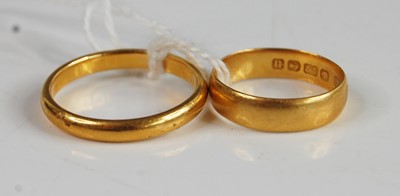 Lot 382 - A 22ct gold wedding band, size T; together...
