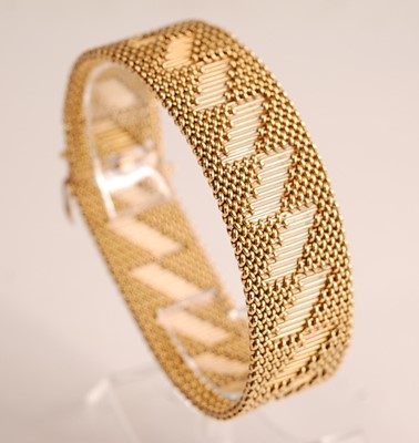 Lot 1090 - A yellow metal interwoven meshlink bracelet,...