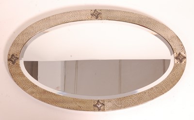 Lot 389 - A 1930s hammered steel clad oval bevelled wall...