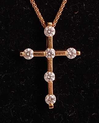 Lot 1100 - An 18ct yellow gold diamond set cross by...