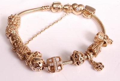 Lot 1134 - A 14ct yellow gold Pandora charm bracelet with...