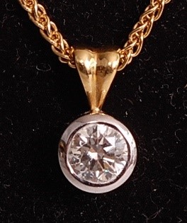 Lot 1101 - An 18ct yellow and white gold single stone...