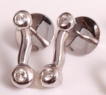Lot 1103 - A pair of 18ct white gold diamond drop...
