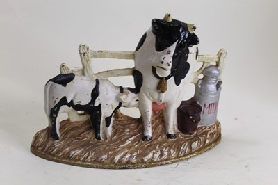 Lot 19 - A cast iron doorstop in the form of a cow and...