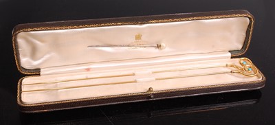 Lot 1112 - A pair of yellow metal hat-pins by George...