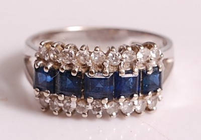 Lot 1110 - An 18ct white gold, sapphire and diamond three-...