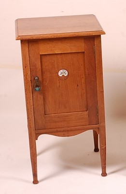 Lot 383 - An Arts & Crafts walnut single door bedside...