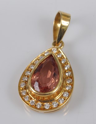 Lot 1126 - A yellow metal, topaz and diamond pear-shaped...