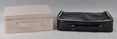 Lot 195 - An Estee Lauder navy blue faux crocodile skin...