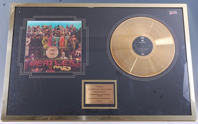 Lot 669 - The Beatles, a gold disc to for the album Sgt....