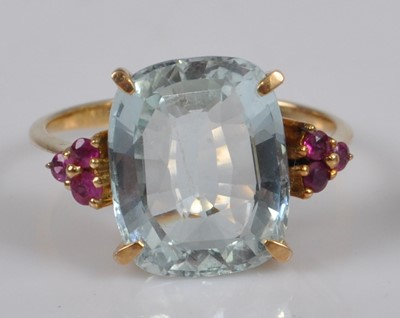 Lot 1117 - A yellow metal, aquamarine and ruby dress ring,...