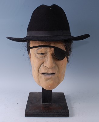 Lot 692 - A life sized painted plaster model head of...