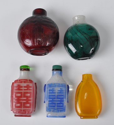 Lot 1228 - A Chinese carved Peking glass snuff bottle, of...