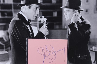 Lot 696 - A red autograph album containing over 50...