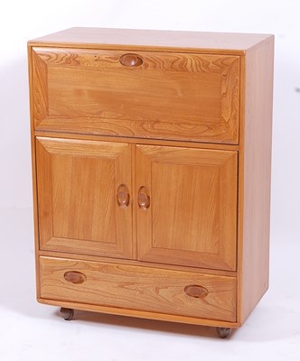 Lot 501 - An Ercol light elm Windsor 469 portable drinks...