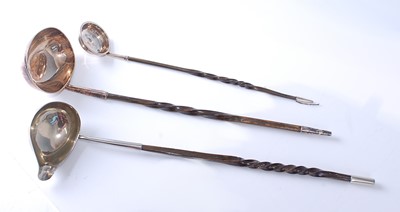 Lot 2141 - Three white metal and twisted horn stemmed...