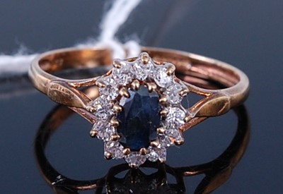 Lot 406 - A 9ct gold blue sapphire and CZ set cluster...