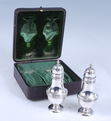 Lot 2166 - A cased pair of Edwardian silver pepperettes,...