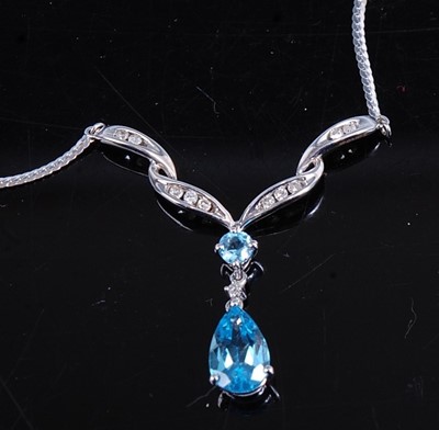 Lot 404 - A modern 9ct white gold, blue topaz and...