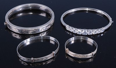 Lot 414 - A modern hollow silver hinged bangle; together...