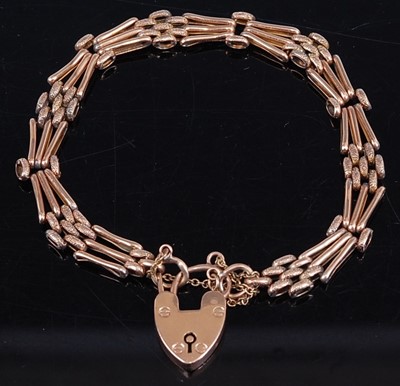 Lot 423 - A 9ct gold gatelink bracelet, with heart...