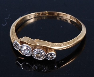 Lot 432 - An 18ct gold diamond crossover ring, arranged...