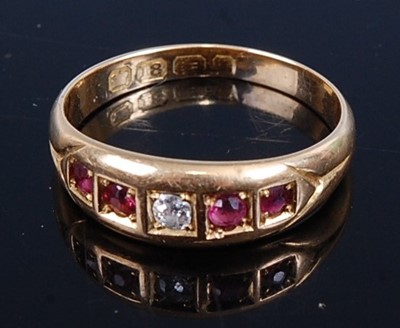 Lot 441 - An 18ct gold, ruby and diamond set half hoop...
