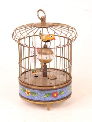 Lot 222 - A reproduction singing bird in cage clock...