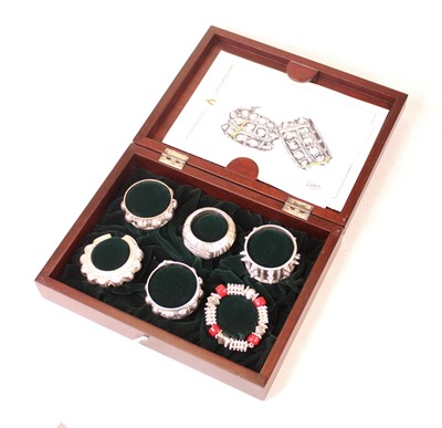 Lot 243 - A boxed set of six white metal Omani napkin...