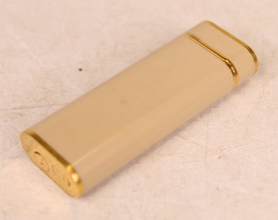 Lot 300 - A Cartier pocket cigarette lighter, the cream...