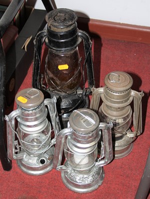 Lot 652 - A collection of four 20th century hurricane lamps