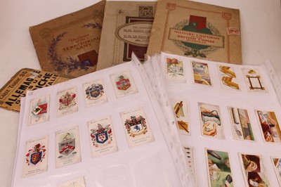 Lot 515 - A collection of cigarette cards arranged in...