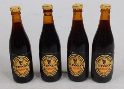 Lot 1517 - A collection of 67 Guinness miniature bottles,...