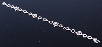 Lot 2340 - An 18ct white gold diamond fancylink bracelet,...