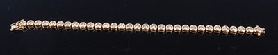 Lot 2332 - An 18ct yellow gold diamond line bracelet,...