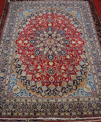 Lot 2591 - A Persian woollen Isfahan carpet, the red...