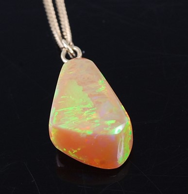 Lot 2361 - A polished opal pendant, of irregular...