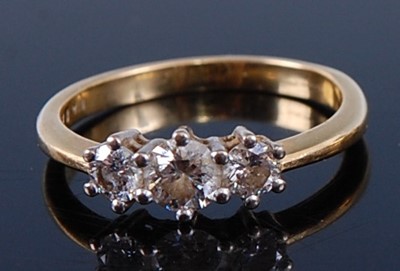 Lot 2365 - An 18ct gold diamond 'trilogy' ring, the claw...